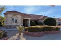 One-story house with stone and tile; landscaped front yard at 8821 Sandspring Dr, Las Vegas, NV 89134