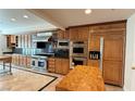 Large kitchen with stainless steel appliances and wood cabinetry at 8821 Sandspring Dr, Las Vegas, NV 89134