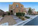 Two story house with a landscaped front yard, brick walkway, and two-car garage at 8853 Sherborne Gate Ave, Las Vegas, NV 89148