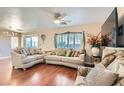 Living room with hardwood floors, sofas, and a large TV at 9462 Diamond Bridge Ave, Las Vegas, NV 89166