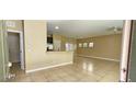 Spacious living room with tile floors and a view of the kitchen at 9490 Alma Ridge Ave, Las Vegas, NV 89178