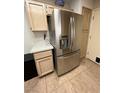 Stainless steel refrigerator in a light wood kitchen at 10065 Hemet Dr, Las Vegas, NV 89134