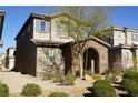 Two-story house with stone accents and a welcoming front porch at 1023 Desert Dome Ave, North Las Vegas, NV 89086