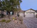 Charming single-story home with stone accents and a paved driveway at 10328 Planter Box St, Las Vegas, NV 89178