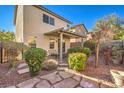 Relaxing backyard with covered patio, stone pathway, and landscaping at 10546 Hartford Hills Ave, Las Vegas, NV 89166