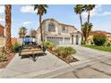 Two-story house with a three-car garage and landscaped yard, boat trailer in driveway at 1138 Aspen Valley Ave, Las Vegas, NV 89123