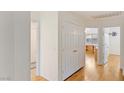 Home hallway with hardwood floors and linen closet at 1420 Ellen Tracy Way, Henderson, NV 89014