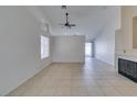 Bright living room with tile floors, fireplace, and vaulted ceiling at 162 Windy Creek Ave, Las Vegas, NV 89123