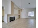 Living room with tile floors, fireplace, and built-in shelving at 162 Windy Creek Ave, Las Vegas, NV 89123