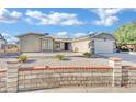 Single-story house with a two-car garage and nicely landscaped front yard at 1627 Candice St, Las Vegas, NV 89156