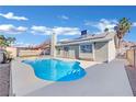 Inviting kidney-shaped pool with a large patio area at 1627 Candice St, Las Vegas, NV 89156