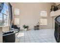 Spacious living room with tile floors and large windows at 2108 Royal Antilles Ct, North Las Vegas, NV 89031