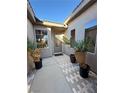 Private courtyard entry with brick pavers and potted plants at 2558 Sparrow Way, Pahrump, NV 89048