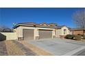 Single-story house with a three-car garage and side yard at 2558 Sparrow Way, Pahrump, NV 89048