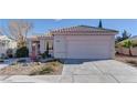 Single story home with a two car garage and desert landscaping at 2693 Hollowvale Ln, Henderson, NV 89052