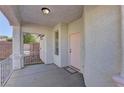 Covered front porch with pink door and white railing at 2693 Hollowvale Ln, Henderson, NV 89052