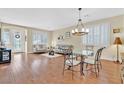 Open living and dining area with hardwood floors and a chandelier at 3065 Lenoir St, Las Vegas, NV 89135