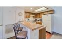 Cozy kitchen with light wood cabinets and a breakfast bar at 3760 Desert Marina Dr # 67, Laughlin, NV 89029