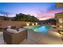 Inviting backyard oasis featuring a rectangular pool, lounge chairs, and outdoor lighting at 39 Cranberry Cove Ct, Las Vegas, NV 89135