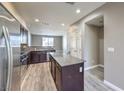 Eat-in kitchen with dark cabinetry, granite countertops, and stainless steel appliances at 4516 Townwall St, Las Vegas, NV 89115