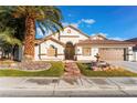 Single-story house with landscaped yard, fountain, and two-car garage at 5522 Oakview Falls Ct, Las Vegas, NV 89148