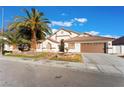 Single-story house with landscaped yard, fountain, and two-car garage at 5522 Oakview Falls Ct, Las Vegas, NV 89148