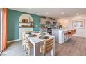 Modern kitchen with gray cabinets, white island, and teal accent wall at 5709 Scarlet Rock St, North Las Vegas, NV 89081