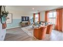 Bright living room featuring terracotta armchairs and a teal sofa at 5709 Scarlet Rock St, North Las Vegas, NV 89081