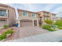 Two-story house with tan exterior, arched garage door, and landscaped front yard at 6034 Pirates Delight Ave, Las Vegas, NV 89139