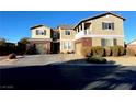 Two-story house with brick and siding, two-car garage, and landscaped yard at 7458 Mezzanine View Ave, Las Vegas, NV 89178