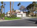 Two-story house with a two-car garage and lush green lawn at 7500 Orange Haze Way, Las Vegas, NV 89149