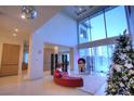 Spacious living room with high ceilings, a curved sofa, and a Christmas tree at 7521 Yonie Ct, Las Vegas, NV 89117