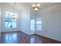 Bright dining room with hardwood floors and large windows at 7608 Botany Bay Dr, Las Vegas, NV 89128