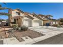 Two-story house with a three-car garage and desert landscaping at 9154 Cazador St, Las Vegas, NV 89123