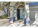 Inviting front door entry with security gate and landscaping at 10140 Heron Island Ave, Las Vegas, NV 89148