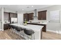 Modern kitchen with island, stainless steel appliances, and dark cabinetry at 11101 Red Yucca Dr, Las Vegas, NV 89138