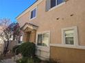 Tan two-story townhouse with front entrance and landscaping at 1142 Grass Pond Pl # 3, Henderson, NV 89002