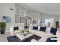 Bright living room featuring a comfortable sectional sofa and a statement coffee table at 1252 Little Sidnee Dr, Las Vegas, NV 89123