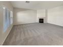 Spacious living room featuring a fireplace and large windows at 170 Rolling Fields Ct, Henderson, NV 89012