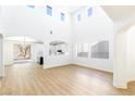 Open concept living room with high ceilings and hardwood floors at 185 Rocky Star St, Henderson, NV 89012