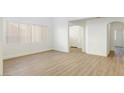 Bright living room with hardwood floors and access to other rooms at 185 Rocky Star St, Henderson, NV 89012
