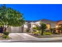 Charming single-story home with a lush, landscaped front yard and a two-car garage at 2336 Indigo Island St, Henderson, NV 89044