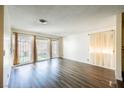 Living room with wood-look floors and patio doors at 2462 Paradise Village Way, Las Vegas, NV 89120