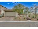 Single-story home with a paved driveway and landscaped front yard at 372 Cooper Hawk Ct, Las Vegas, NV 89138