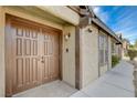 Front entry with double wood doors and walkway at 3971 Foxboro Cir, Las Vegas, NV 89121