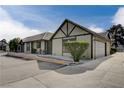 House exterior showcasing a light-tan color scheme, garage, and landscaping at 3971 Foxboro Cir, Las Vegas, NV 89121