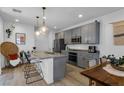Spacious kitchen featuring gray cabinets, granite counters, and stainless steel appliances at 92 Kimberlite Dr, Henderson, NV 89011