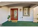 Inviting front entrance with red door and decorative wreath at 11015 Dornoch Castle St, Las Vegas, NV 89141