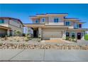 Two-story home with a two-car garage and stone facade at 129 Barringswell Ave, Henderson, NV 89011