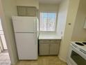 White refrigerator and taupe cabinets in this kitchen at 2036 Mesquite Ln # 303, Laughlin, NV 89029